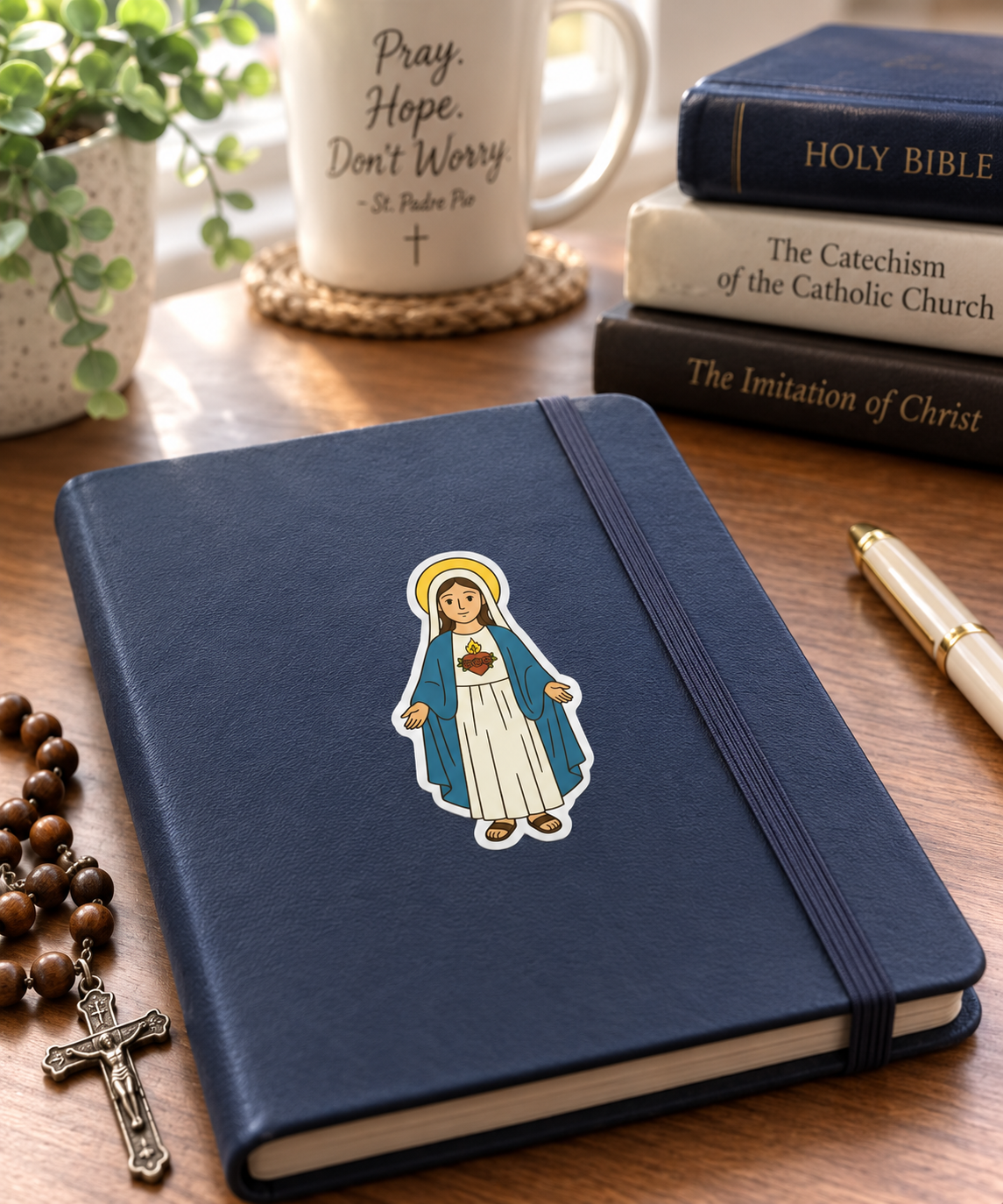 Immaculate Heart of Mary vinyl sticker on a notebook