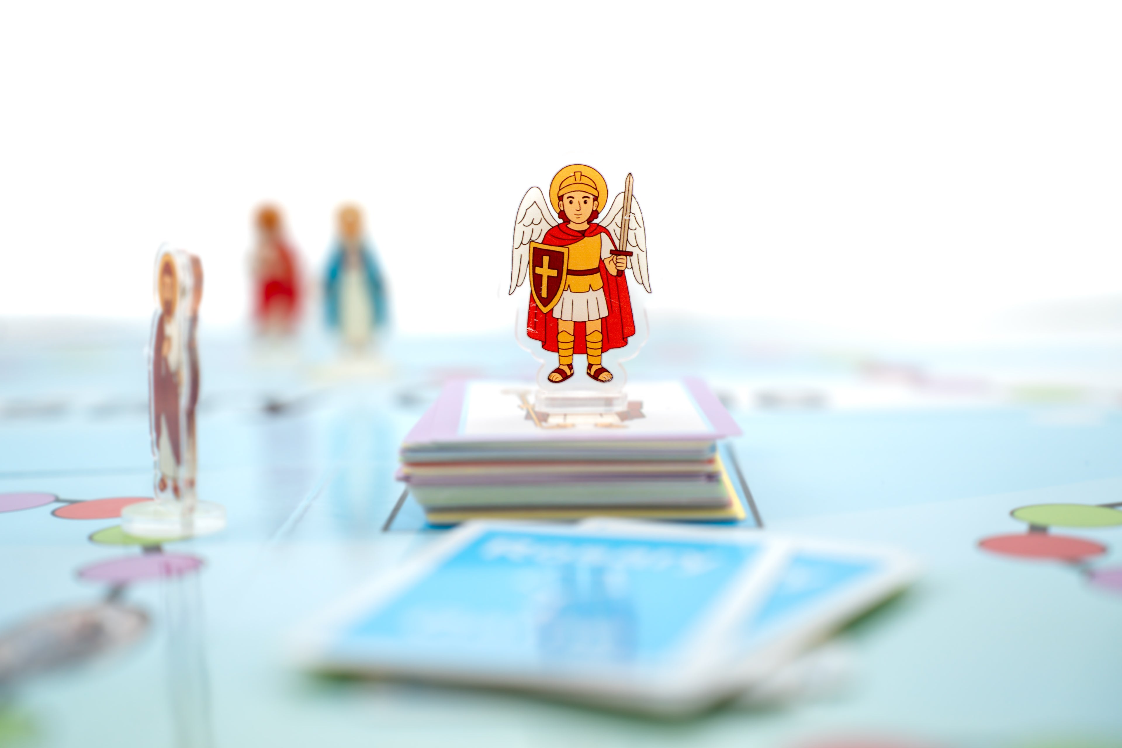 Acrylic saint figures included in the Rosary Game
