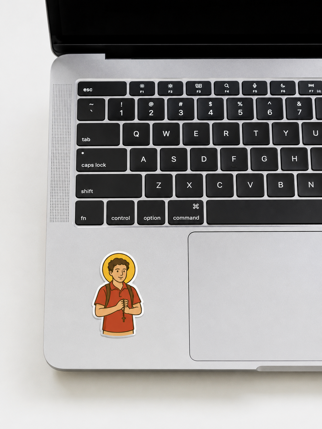St. Carlo Acutis vinyl sticker on a computer keyboard